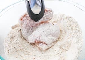 Dredge chicken in flour mixture, coating on both sides