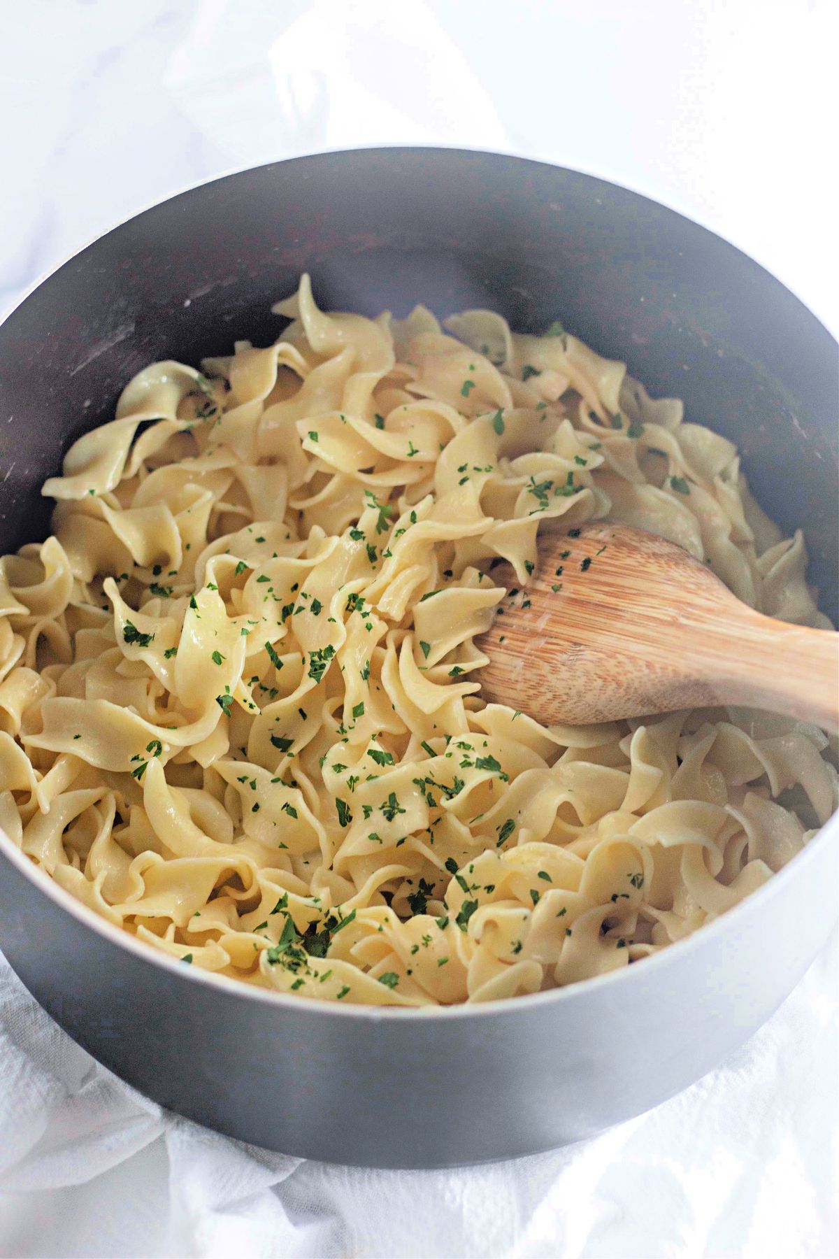 Lemon buttered noodles in a pot.