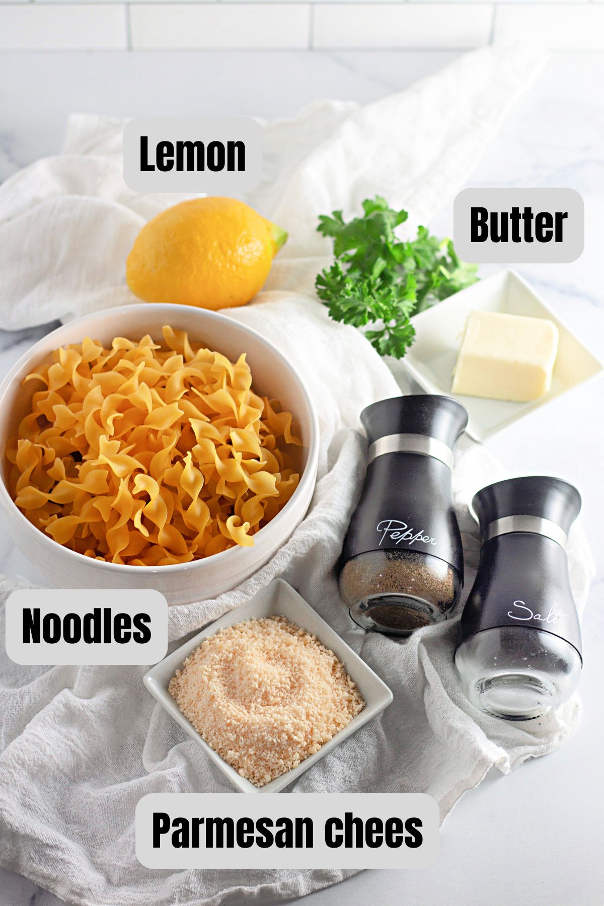 Ingredients for lemon buttered noodles on a table.