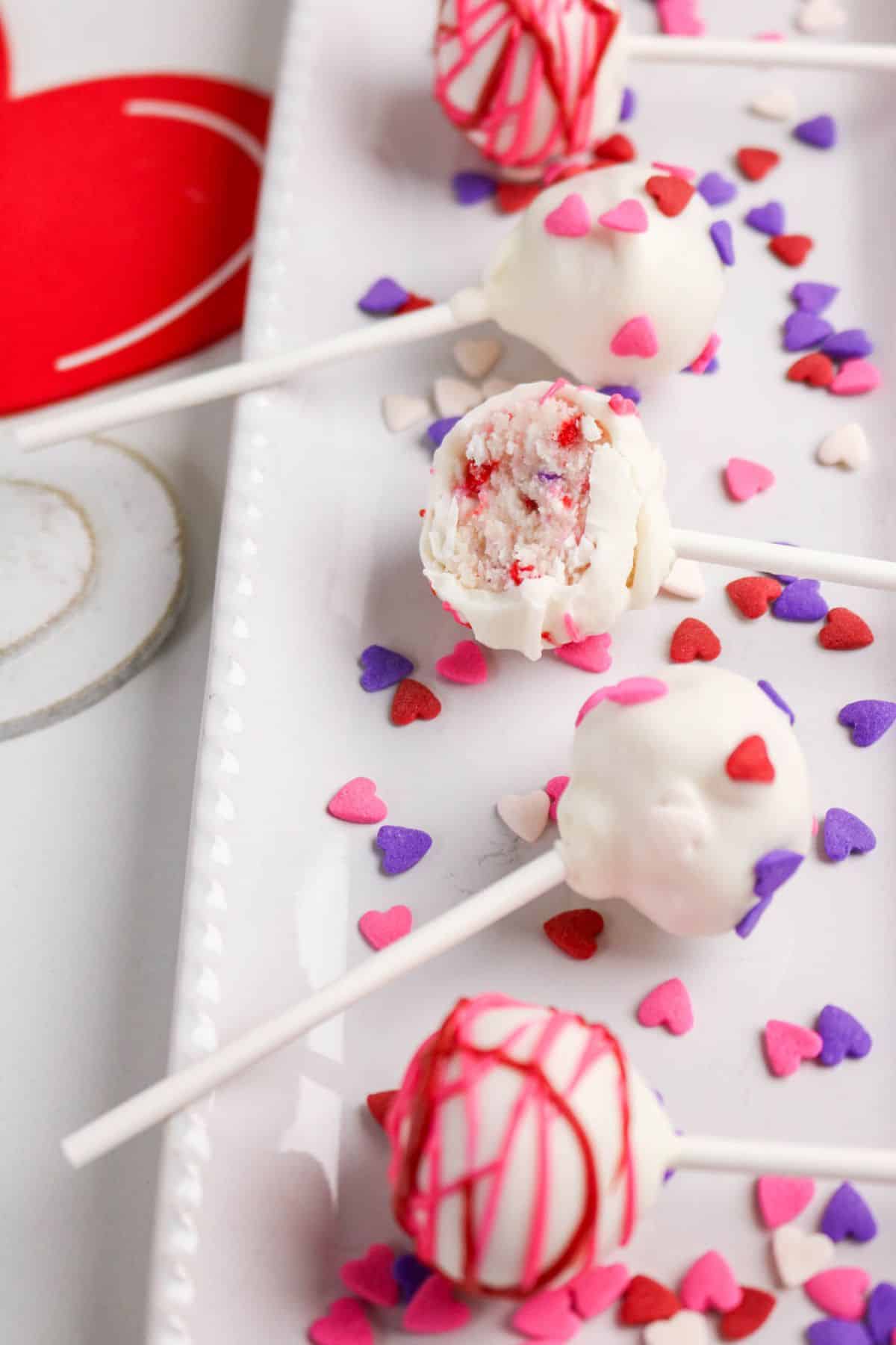A cake pops on a plate.